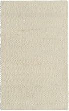 A textured looped and sheared ivory-colored handwoven wool rug