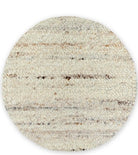 A round Belgium wool rug with a textured looped and sheared design in mushroom color.