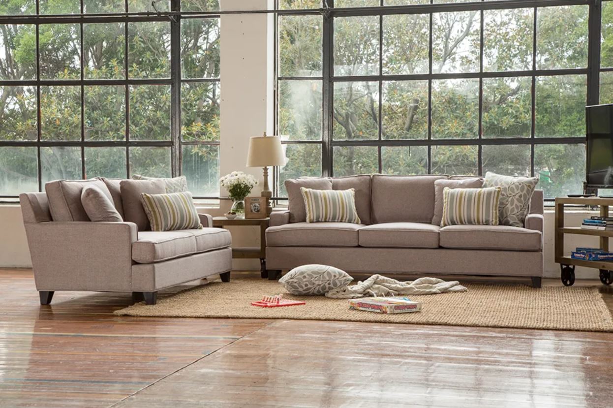 Living room with beige sofa set and large windows