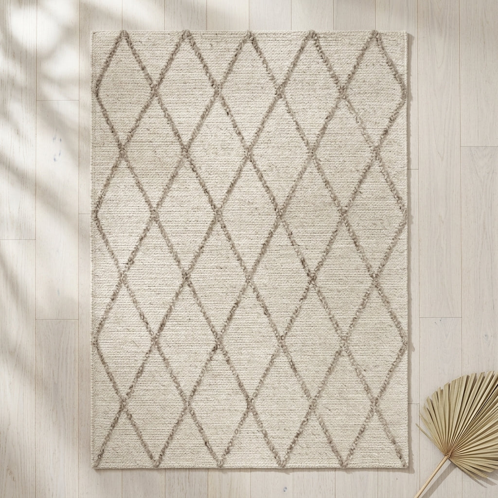 Beige area rug with diamond pattern on a light wooden floor