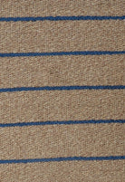 Textured fabric with blue stripes on a brown background