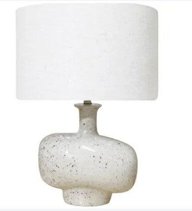 Table lamp with a white ceramic base and white shade on a white background
