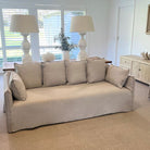 Beige sofa in a living room with lamps and decor