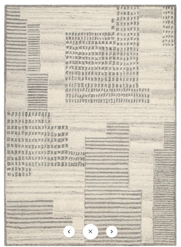 Patterned rug with geometric design on a plain background