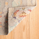 Textured rug with colorful pattern on a wooden floor