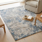 Living room with a patterned rug, beige sofa, and wooden coffee table.