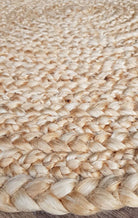 Close-up of a woven jute rug with natural beige color.