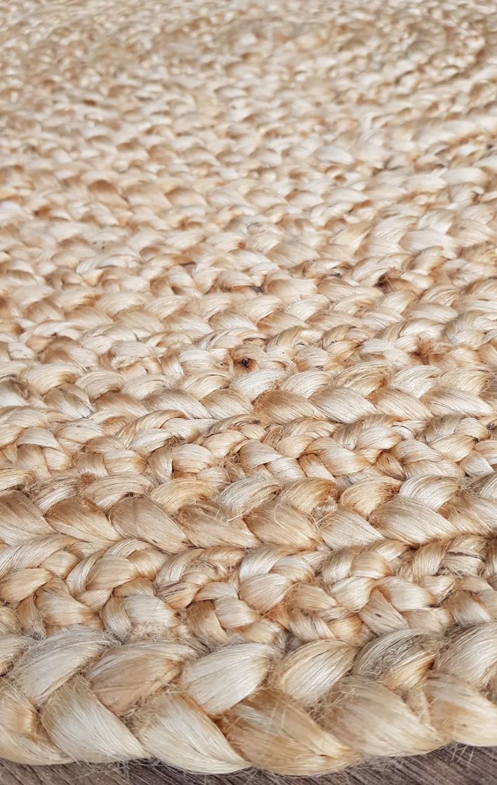 Close-up of a woven jute rug with natural beige color.