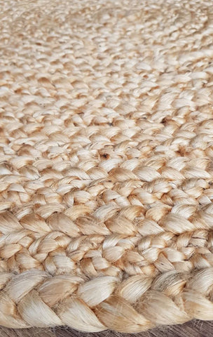 Close-up of a woven jute rug with natural beige color.