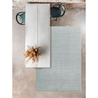 Textured rug with geometric pattern on a concrete floor