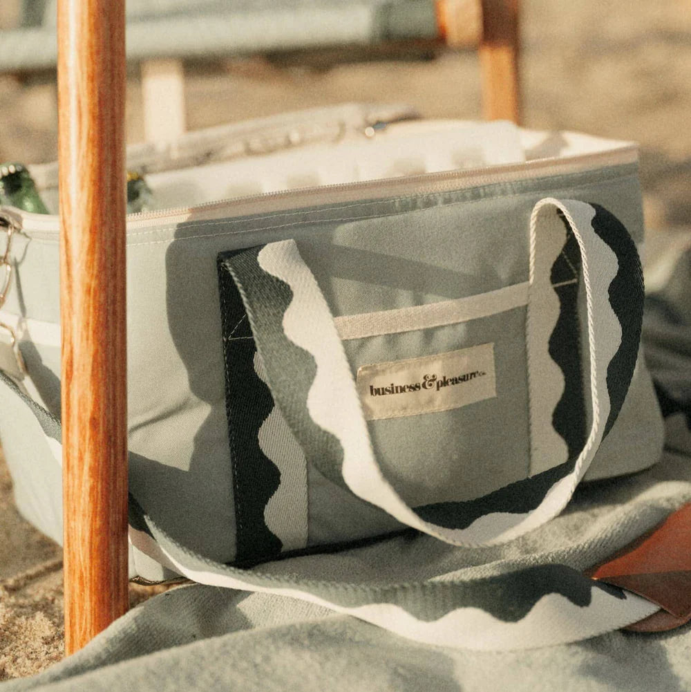 Camouflage-patterned bag with a visible brand logo on a blurred background