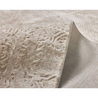 Textured beige fabric with a subtle pattern on a white background