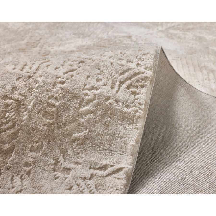 Textured beige fabric with a subtle pattern on a white background