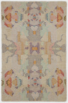 Decorative rug with a central figure and floral patterns on a beige background