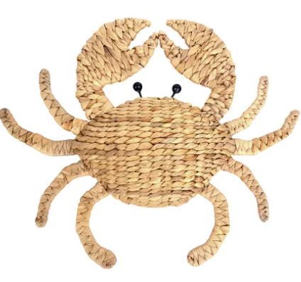 A woven straw crab wall decor piece with black bead eyes, shown against a plain white background.