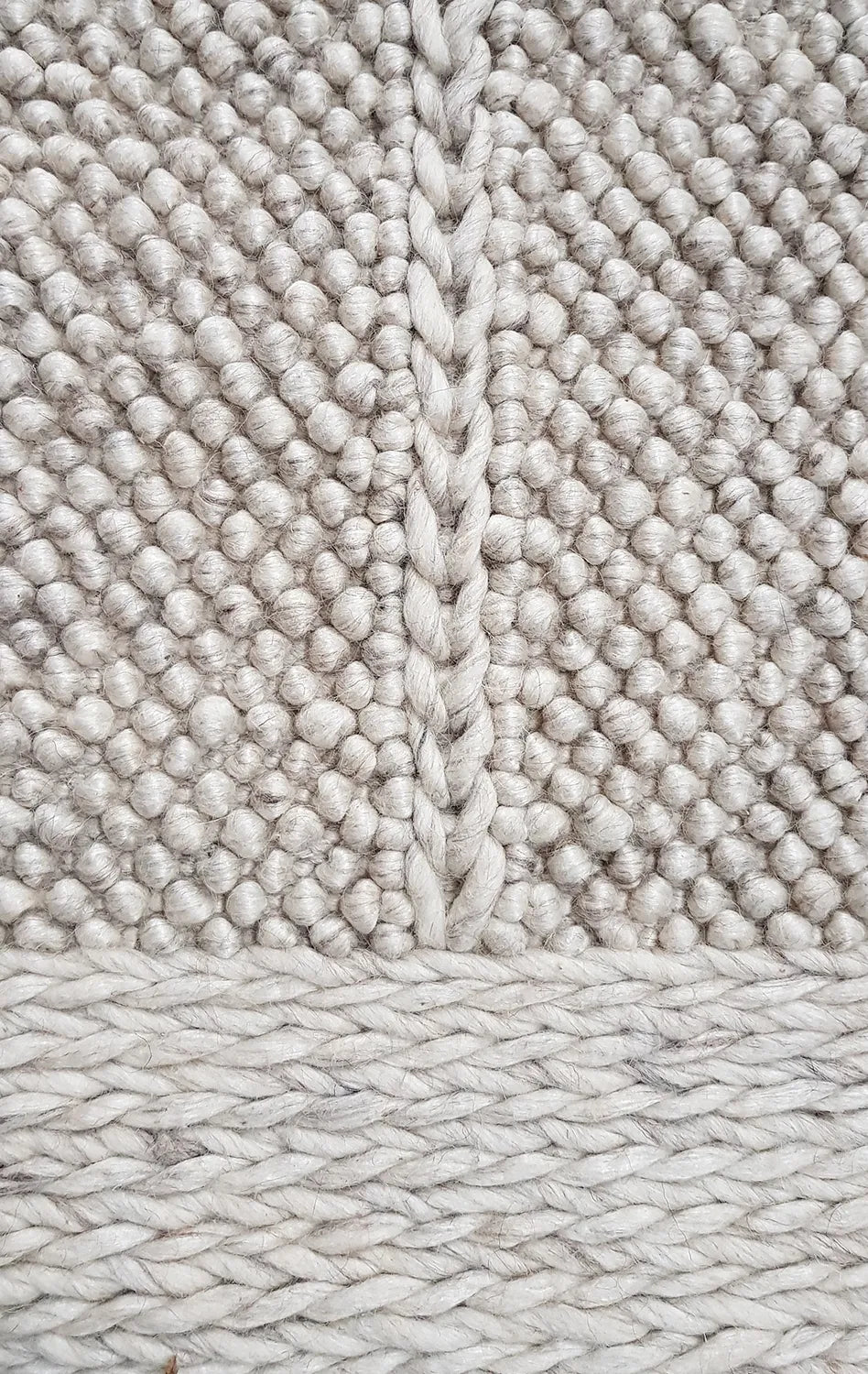 Close-up of textured beige carpet with a woven pattern