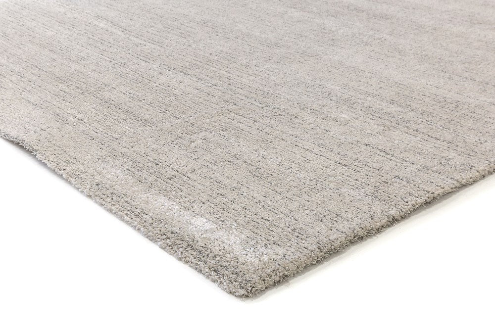 Zoomed-in view of the edge of the Cumulus Rug in Stone, highlighting the fine craftsmanship and durable weave.