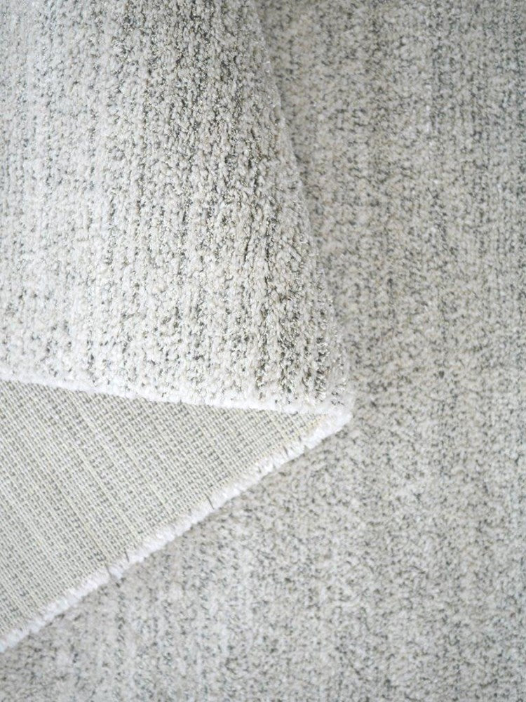 Close-up of a textured gray fabric with a subtle pattern