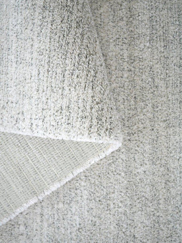 Close-up of a textured gray fabric with a subtle pattern