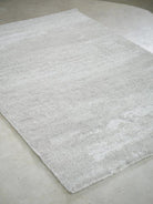Gray textured rug on a concrete floor