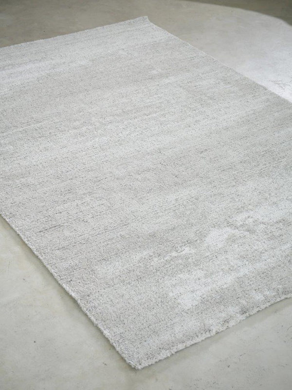 Gray textured rug on a concrete floor