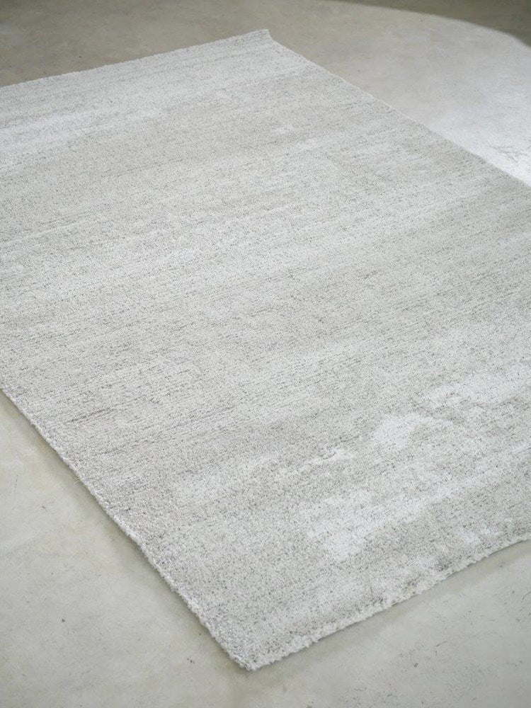 Gray textured rug on a concrete floor