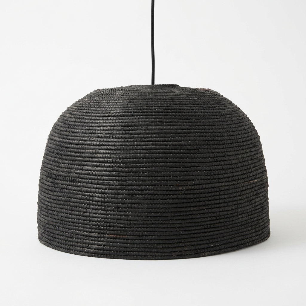A black woven pendant light shade with a textured, ribbed pattern, suspended by a thin black cord against a plain white background.