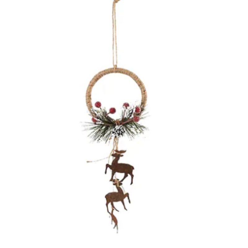 A rustic Christmas wreath hanging ornament made of a natural woven ring with faux pine branches, red berries, and two dangling metal reindeer figures, shown against a plain white background.