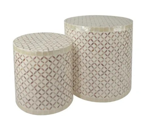 Two cylindrical mosaic tables with geometric patterns on a white background