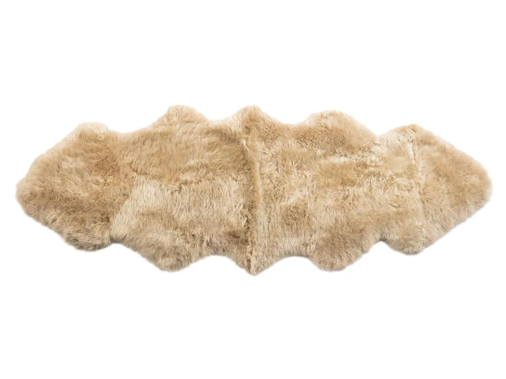 Beige sheepskin rug on a white background