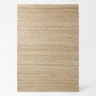A rectangular area rug with a horizontal woven texture, featuring a repeating geometric pattern in warm beige and light brown tones, shown against a plain white background.