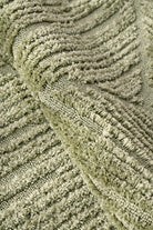 Close-up of textured green fabric with wavy pattern