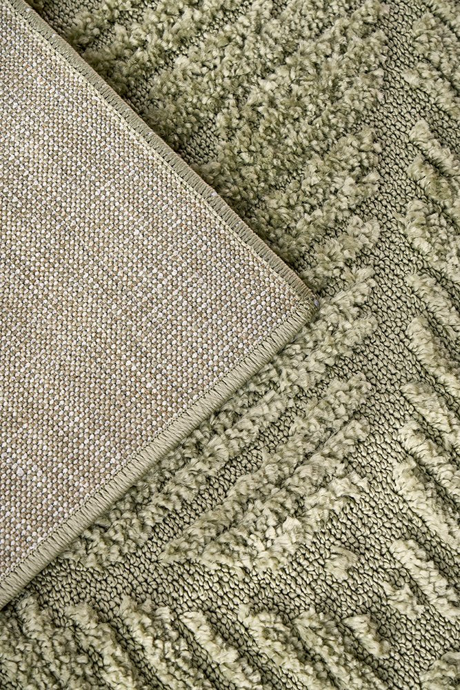 Close-up of textured green and beige carpet samples