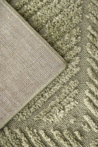 Close-up of textured green and beige carpet samples