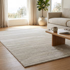 Living room with a beige rug, wooden coffee table, and a couch.