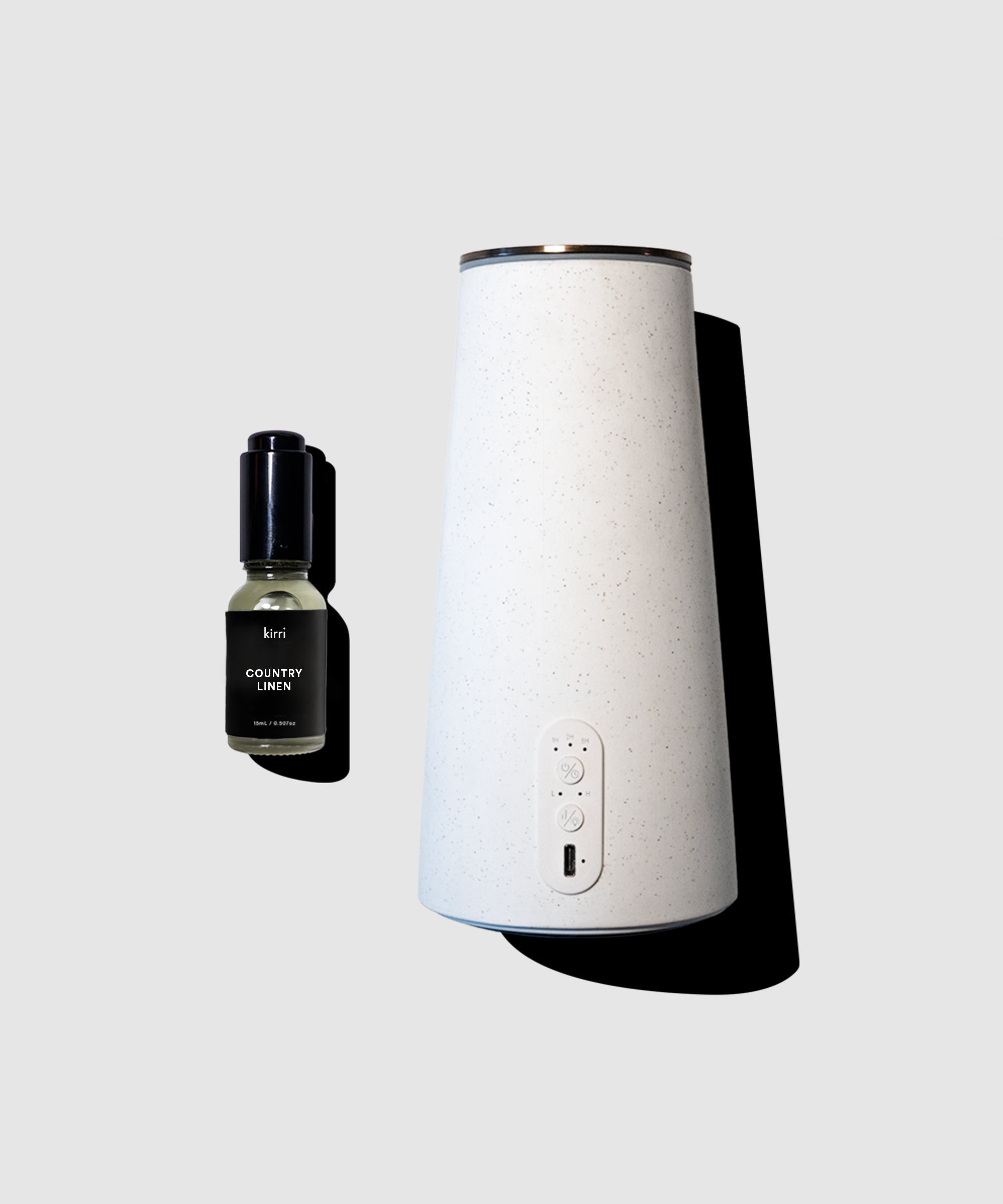 White diffuser and black bottle on a light gray background