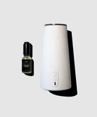 White diffuser and black bottle on a light gray background