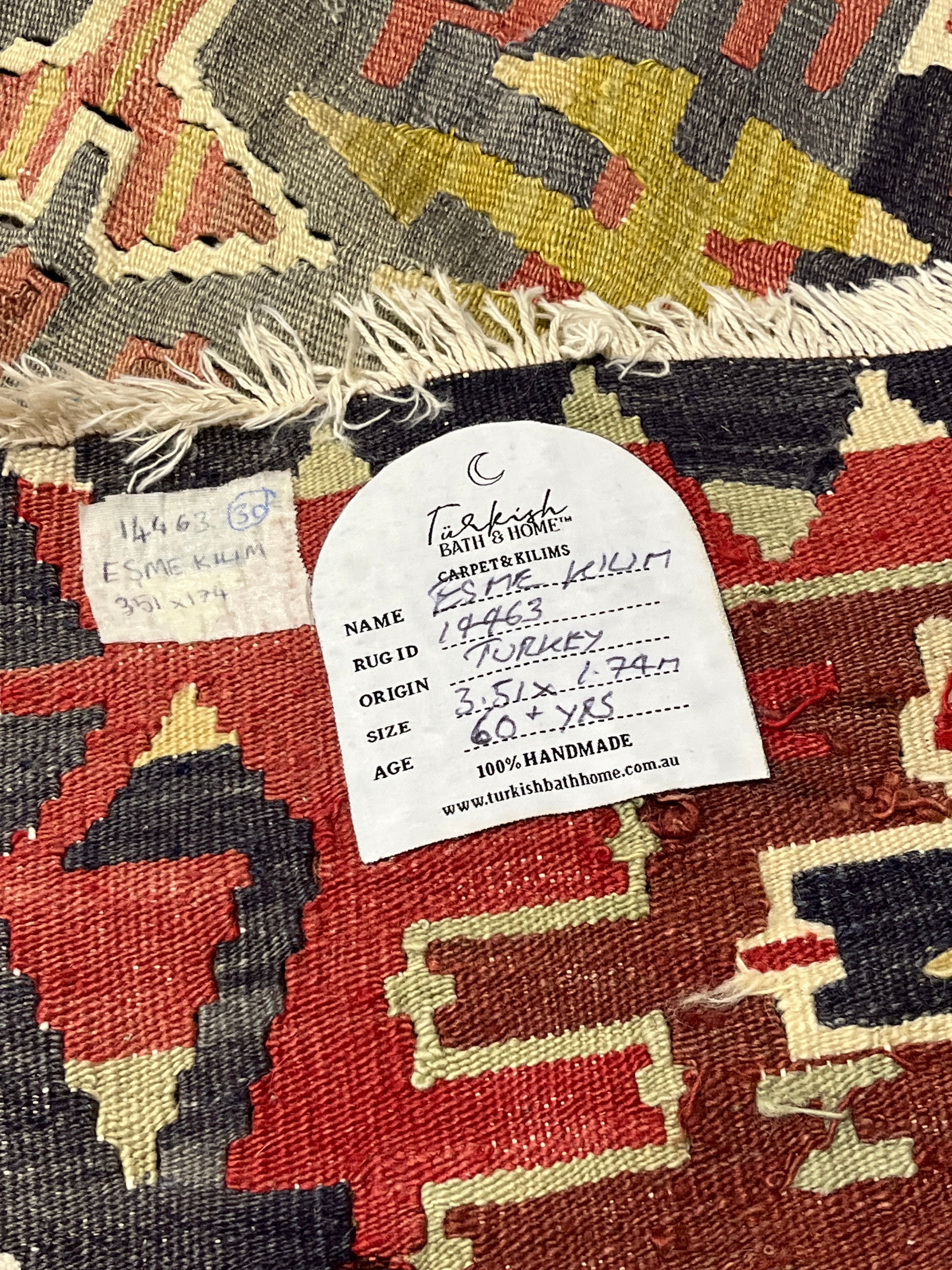 Close-up of a patterned rug with a label on it