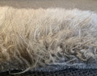 Close-up of textured fabric with a focus on fibers