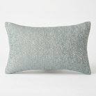 A rectangular lumbar throw pillow in a textured, woven fabric with a mottled pattern of light blue and off-white threads, shown against a plain white background.
