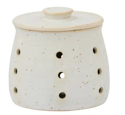 White ceramic oil burner with holes and a lid on a white background