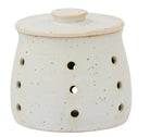 White ceramic oil burner with holes and a lid on a white background