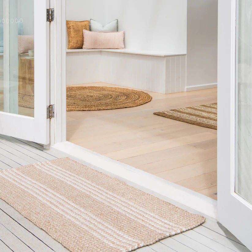 Rug on a wooden floor with a neutral color scheme