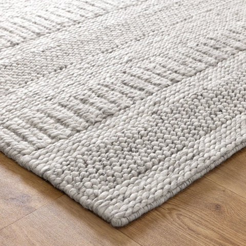 Close-up view of a grey wool and nylon area rug with a textured pattern