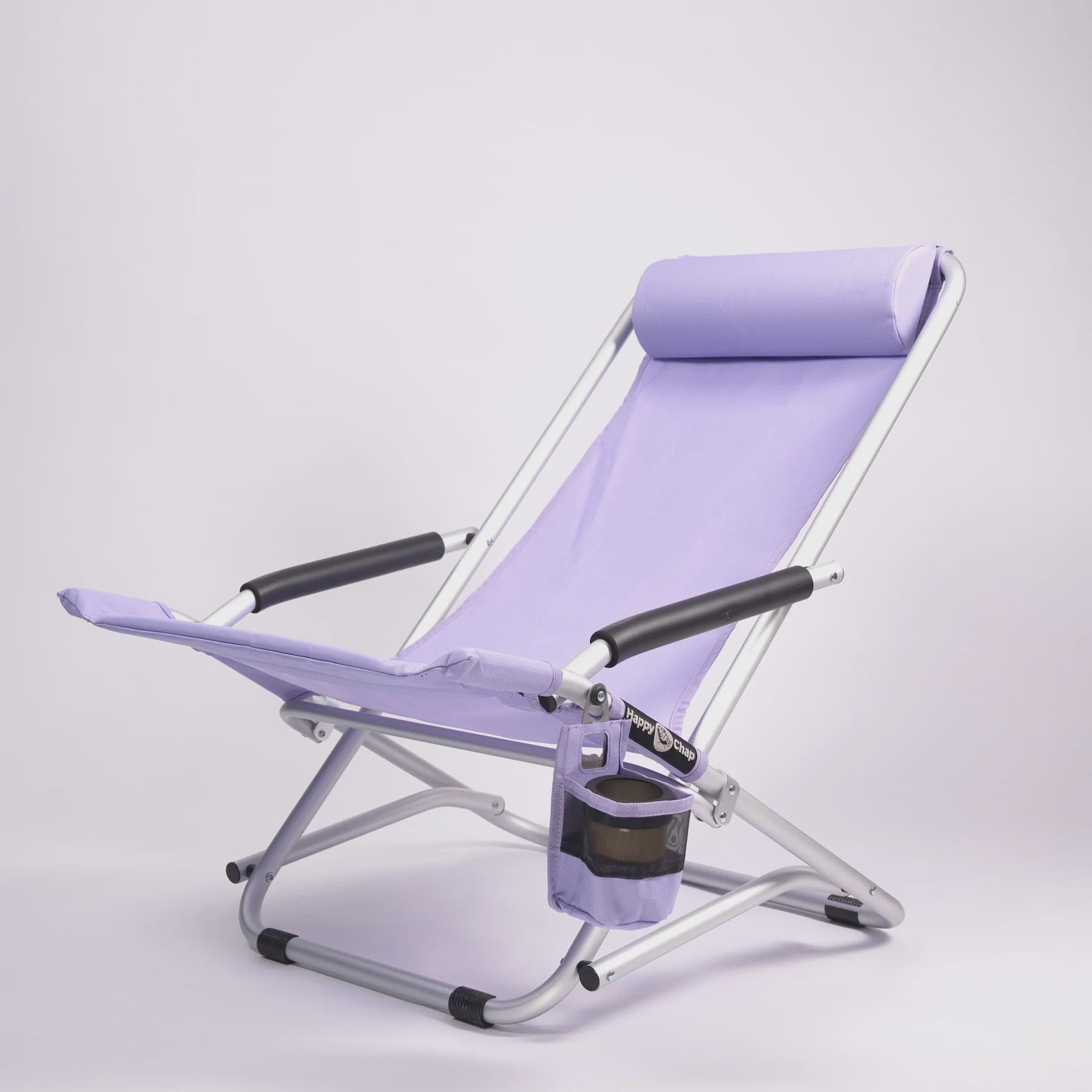 Purple folding beach chair with cup holder on a white background