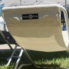 Beige folding chair with 'Happy Chap' logo on a grassy area