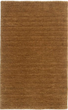 A honey brown Harlequin textured wool rug with a plush, chunky woven style.