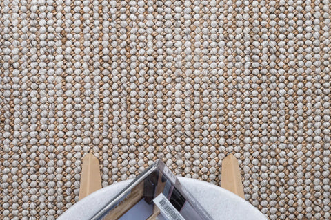 An image showing the Harmony Rug in a room setting, illustrating how its natural and silver tones complement modern interiors and add a touch of sophistication.
