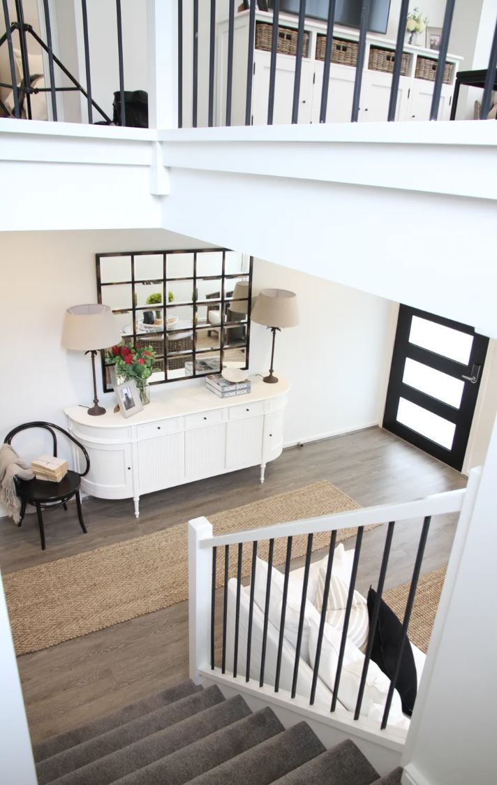 Staircase with a small sitting area and decorative items in a home interior.