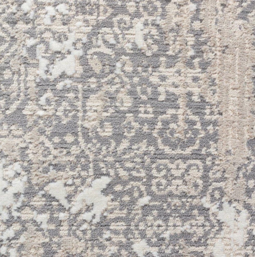 Close-up of a textured rug with a geometric pattern in neutral colors.